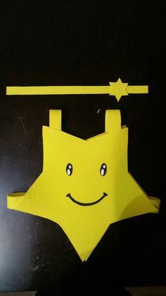 an origami star hanging on a clothesline with a smile drawn on it