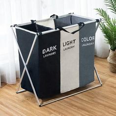 two black and white laundry bins sitting on top of a wooden floor