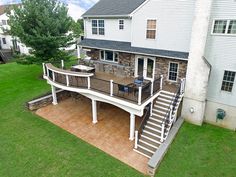 an aerial view of a deck and patio in the back yard with stairs leading up to it