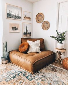 a living room filled with furniture and pictures on the wall