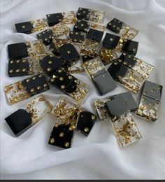 many black and gold square shaped beads on a white cloth