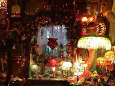 a room filled with lots of different types of lights and decorations on the wall next to a window