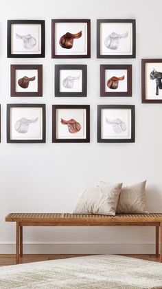 a wooden bench sitting in front of a wall with pictures on it