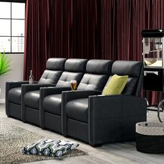 a living room filled with black leather furniture