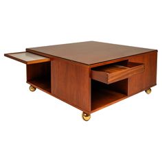 a wooden coffee table with two drawers on each side and one open drawer in the middle