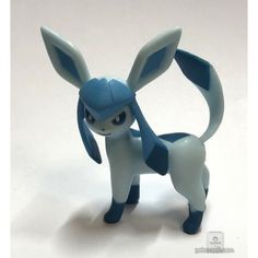 a toy figure is shown on a white surface with blue and gray colors, it looks like an animal that appears to be in the form of a pikaba