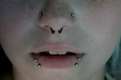 a woman with piercings on her nose