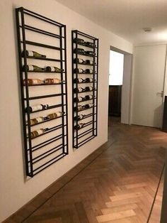 there is a wine rack on the wall in this room with wood flooring and white walls