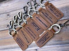 four leather keychains with personalized tags attached to them