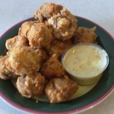 fried food on a plate with dipping sauce