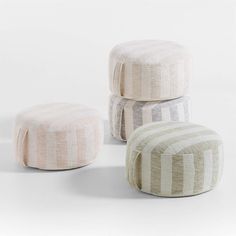 three small stools are stacked on top of each other in different colors and patterns