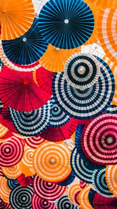 an image of colorful umbrellas that are on the wall in front of it's frame