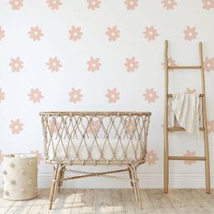 a baby crib in front of a wall with stars on it and a ladder leaning against the wall