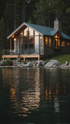 a house sitting on top of a lake next to a forest