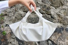 "🔘 This Elegant Satin Knot bag is ideal for the wedding day, night out, party, special occasion, brides, bridesmaids, mothers of the bride, or any formal fun. 🔘 This bag has a snap closure and is inside a felt pouch. The Video shows the handbag in a small size. You can put an iPhone plus into the bag and also some other essentials in it. is perfect for a night-out bag - comfortably fits my iPhone 12, lipstick, and a coin purse.   🔘 Dimensions of the inside felt pouch: SMALL SIZE:  L16 x H8 x Chic Top Handle Shoulder Bag For Wedding, Cream Top Handle Party Bag, Cream Top Handle Bag For Party, Chic Handheld Shoulder Bag For Wedding, Chic Pouch Evening Bag, Chic Handheld Wedding Shoulder Bag, Party Cream Top Handle Bag, Summer Formal Cream Bags, Cream Summer Formal Bags