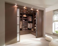 an empty walk in closet with lights on the ceiling