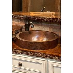 a bathroom sink sitting on top of a wooden counter