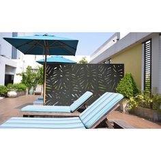 two lounge chairs and an umbrella are on the roof terrace near a building with plants