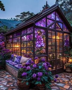 a glass house with purple flowers in it