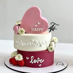 a three tiered cake decorated with hearts and flowers