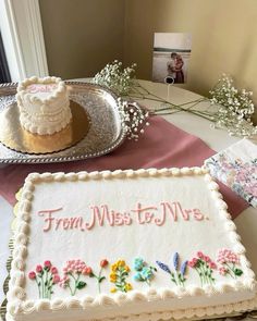 there is a cake on the table with flowers