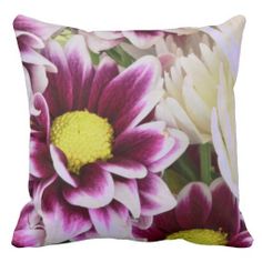 a close up of a pillow with flowers on the front and back side, all in different colors