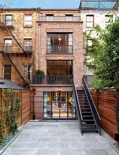 an apartment building with stairs leading up to the second floor