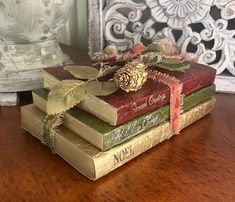 a stack of books sitting on top of a wooden table