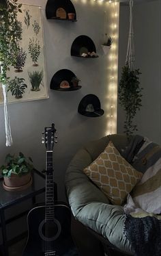 a guitar sits in the corner of a room with plants and lights on the wall