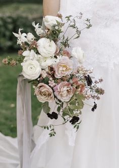 a bride holding a bouquet of flowers in her hands