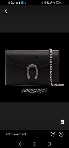 a black purse with a chain around the strap and an inscription that says, add comment