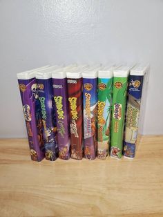 a row of candy bars sitting on top of a wooden table next to a white wall