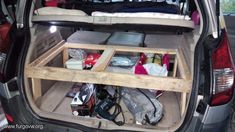 the back end of a car with its trunk open and various items in it's cargo compartment