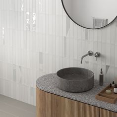 a bathroom with a sink, mirror and soap dispenser on the counter