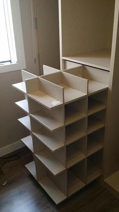 an empty shelf in the corner of a room