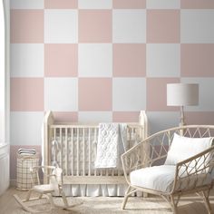 a baby's room with pink and white checkered wallpaper, rocking chair and crib