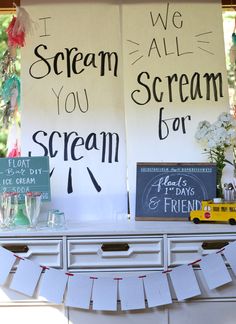 a white dresser topped with lots of writing on it's sides next to a sign that says scream all you scream for