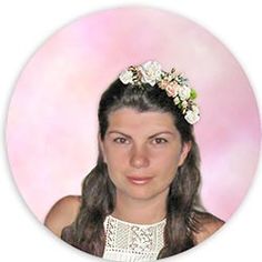 a woman with long hair wearing a flowered headband in front of a pink background