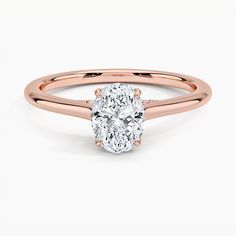 a rose gold engagement ring with a oval cut diamond