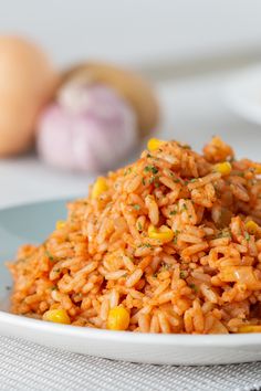 a white plate topped with rice and corn