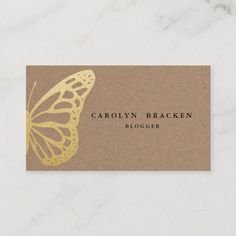 a brown and gold business card with a butterfly on the front, which reads, caroln bracken blogger