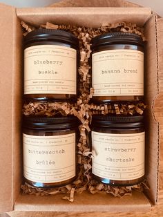 four jars of blueberry blocks in a cardboard box