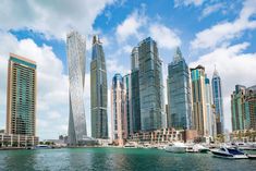 several boats are in the water near some tall buildings