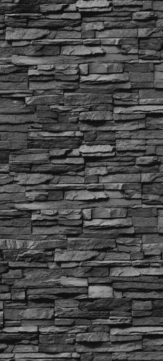 a black and white photo of a stone wall