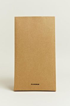 a brown notebook sitting on top of a white surface