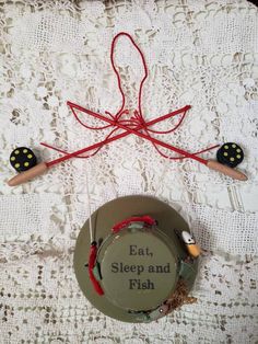 an image of eat, sleep and fish on the table with red string attached to it