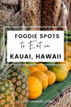 some pineapples, oranges and bananas are on display with the words foodie spots to fatin kauai, hawaii