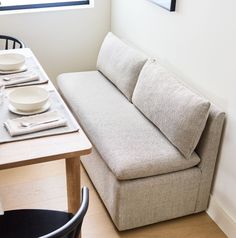 a couch sitting next to a table with plates on it