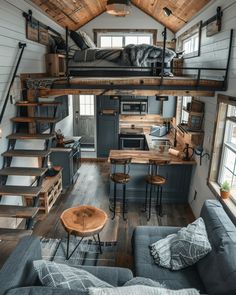 a loft bed with stairs leading up to it and a couch in the corner next to it