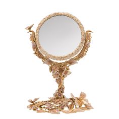 an ornately decorated mirror on a stand with flowers and leaves around the edge, against a white background